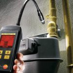 Handheld moisture meter with digital display and flexible probe for plumbing assessments by Quahog Plumbing in Somerset, MA.